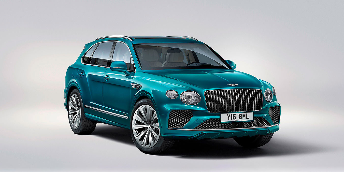 Bentley Zug Bentley Bentayga Azure front three-quarter view, featuring a fluted chrome grille with a matrix lower grille and chrome accents in Topaz blue paint.