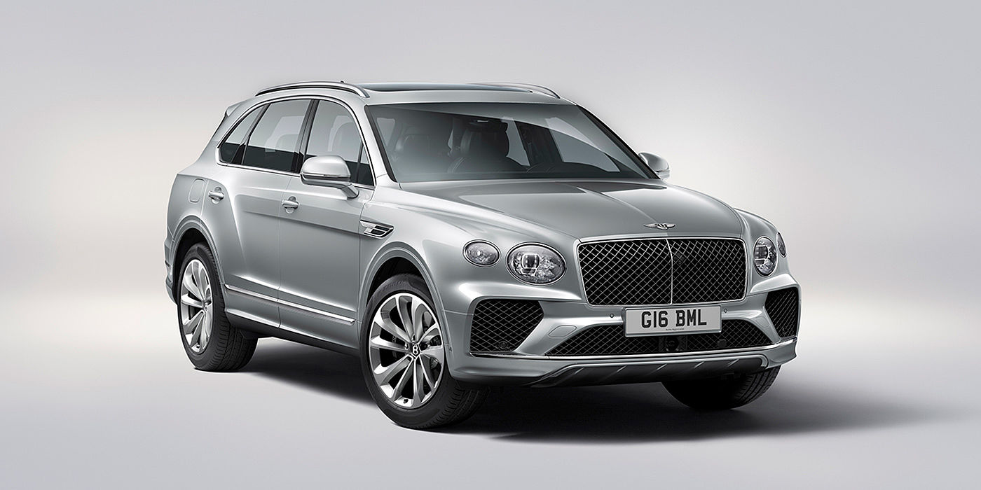 Bentley Zug Bentley Bentayga in Moonbeam paint, front three-quarter view, featuring a matrix grille and elliptical LED headlights.
