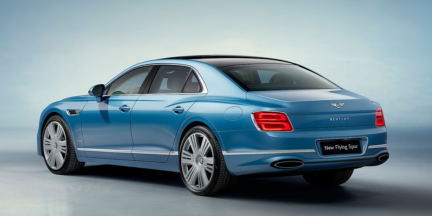 Bentley Zug New Bentley Flying Spur Azure sedan rear view in Light windsor blue by Mulliner paint with 22 inch Azure wheels and chrome exterior details
