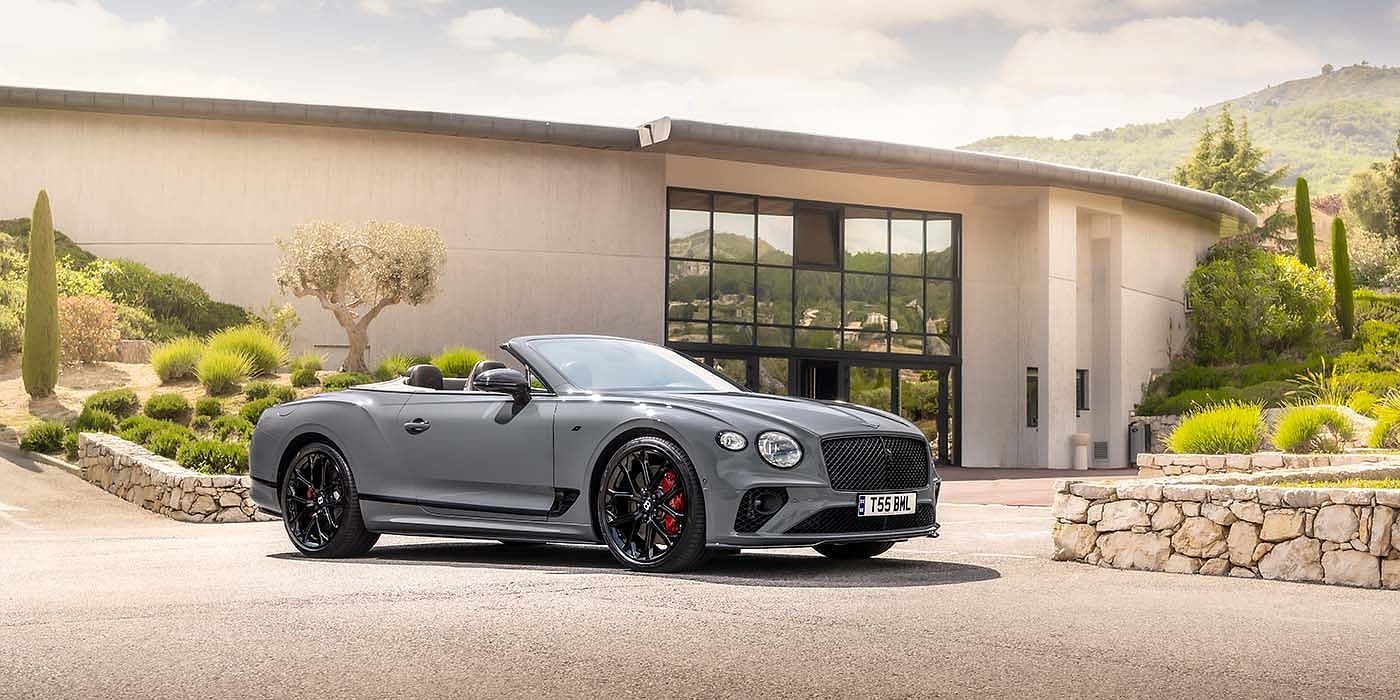 Bentley Zug Bentley Continental GTC S convertible in Cambrian Grey paint front 34 static near house