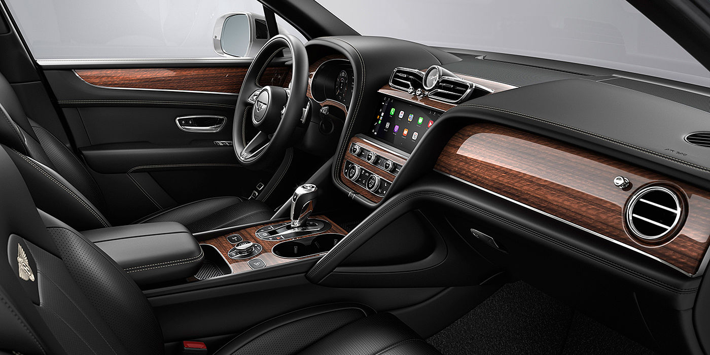 Bentley Zug Bentley Bentayga interior with a Crown Cut Walnut veneer, view from the passenger seat over looking the driver's seat.