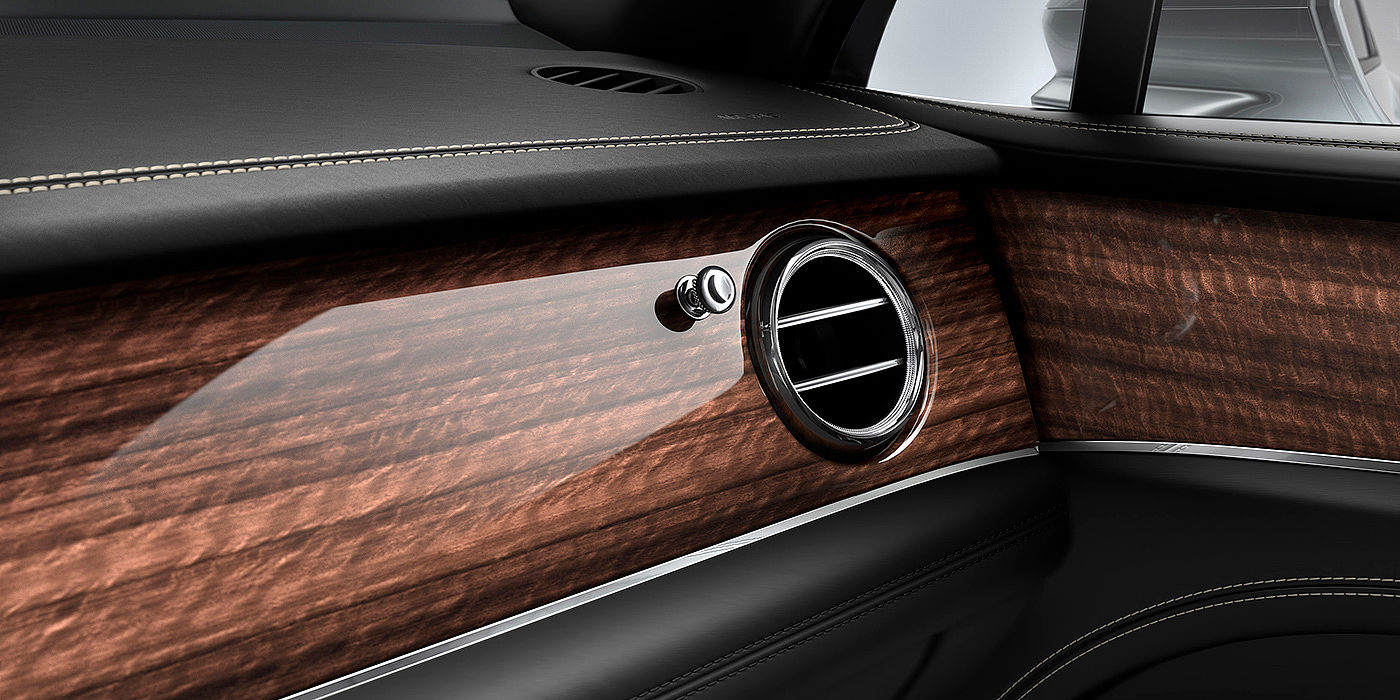 Bentley Zug Bentley Bentayga front interior Crown Cut Walnut veneer and chrome air vent.