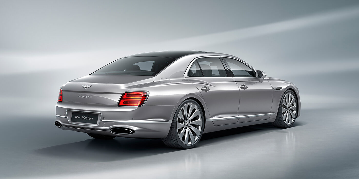 Bentley Zug New Bentley Flying Spur sedan rear view in Silverlake paint with ten spoke wheels and chrome matrix grille