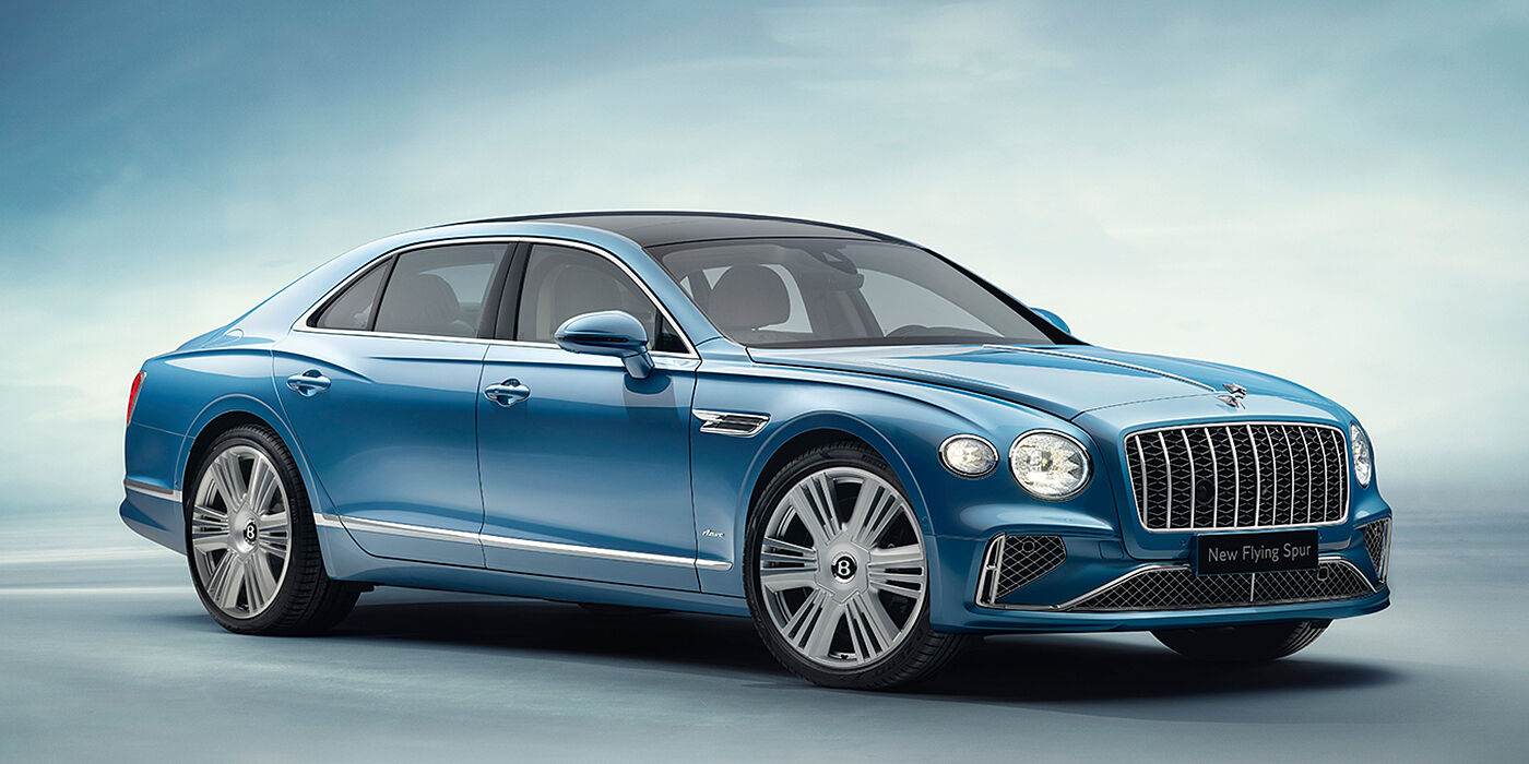 Bentley Zug New Bentley Flying Spur Azure sedan front view in Light windsor blue by Mulliner paint with 22 inch Azure wheels and chrome exterior details