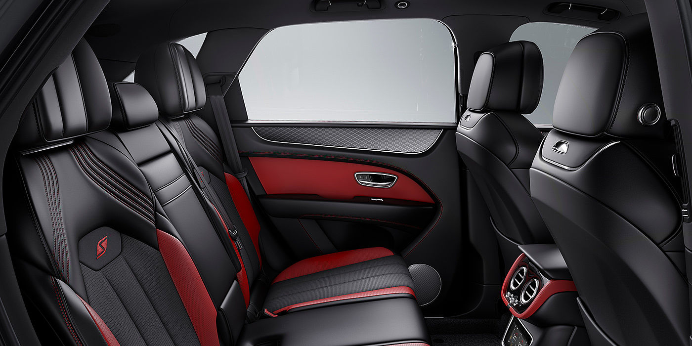 Bentley Zug Bentey Bentayga S interior view for rear passengers with Beluga black and Hotspur red coloured hide.