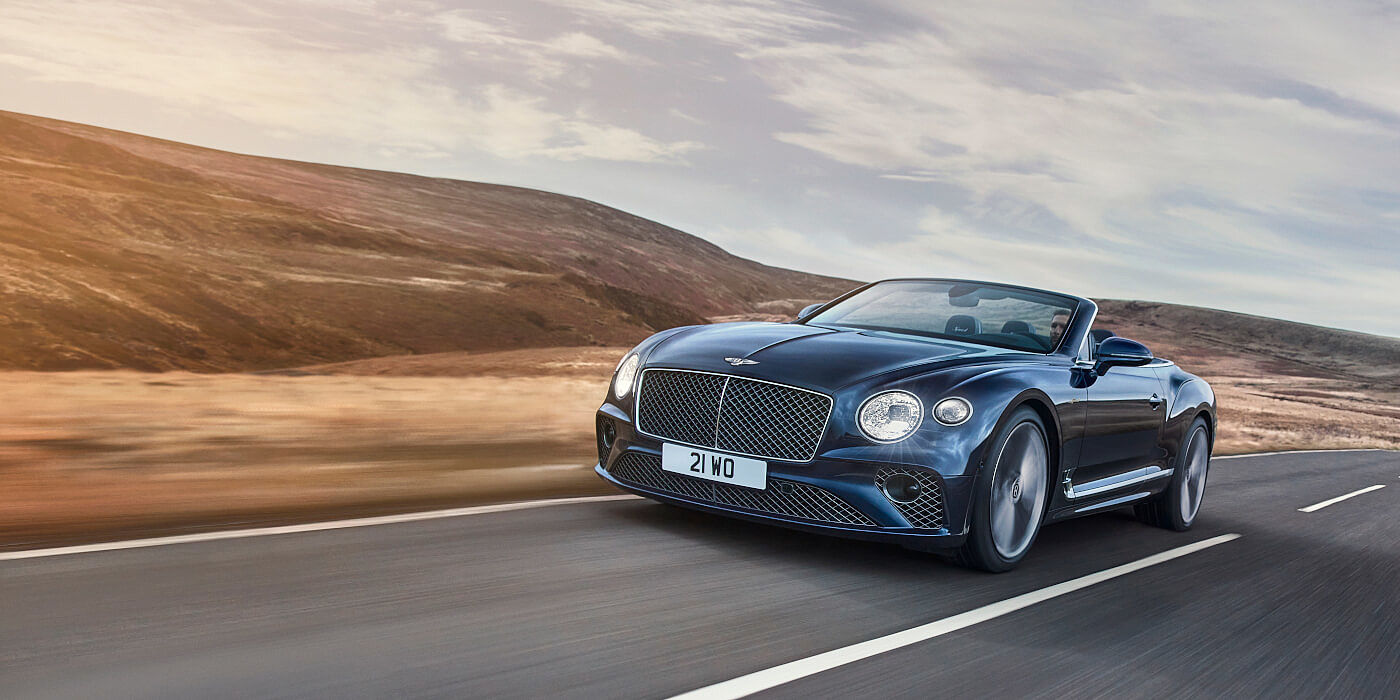Bentley Zug Bentley Continental GTC Speed convertible in Peacock paint side front 34 dynamic