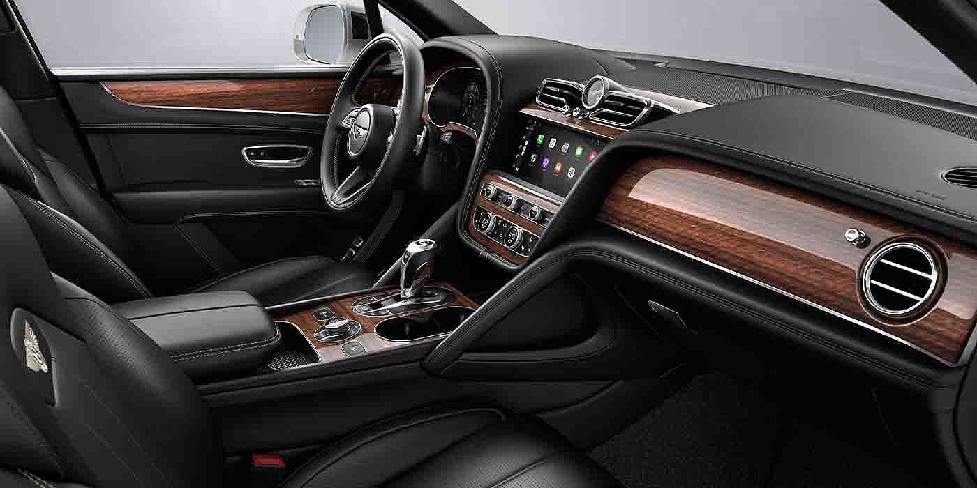 Bentley Zug Bentley Bentayga EWB interior with a Crown Cut Walnut veneer, view from the passenger seat over looking the driver's seat.