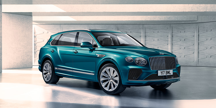 Bentley Zug Bentley Bentayga Extended Wheelbase Azure SUV front three quarter in Topaz blue paint colour with a grey background