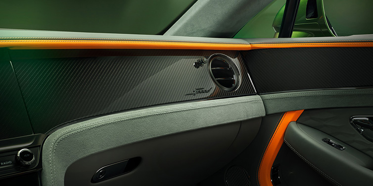 Bentley Zug Bentley Continental GT Speed coupe front interior dash detail with high gloss carbon fibre veneer surrounded by Mandarin by Mulliner and Gravity Grey hides