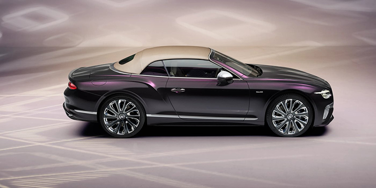 Bentley Zug Bentley Continental GTC Mulliner convertible in profile with hood up, in Tanzanite Purple paint and 22 inch Mulliner painted and polished wheels