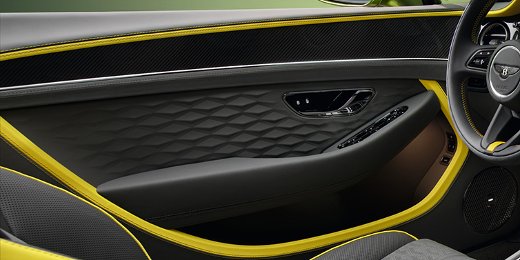 Bentley Zug Bentley Continental GTC Speed convertible interior door details featuring Gravity Grey and Cyber Yellow by Mulliner hides and high gloss carbon fibre veneer