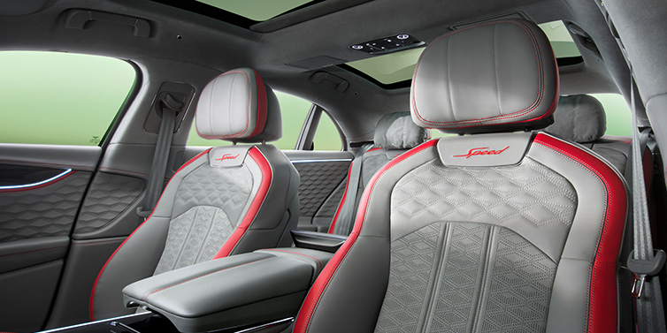 Bentley Zug Bentley Flying Spur Speed sedan interior showing front and rear seats in Hotspur red and Gravity Grey hides, with Speed seat emblems