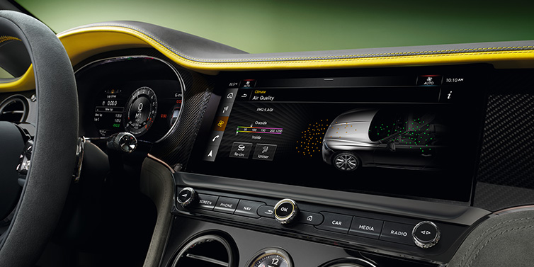 Bentley Zug Bentley Continental GTC Speed convertible front interior centre console with MMI screen showing Air Quality visualisation surrounded by Cyber Yellow by Mulliner and Gravity Grey hides and high gloss carbon fibre veneer