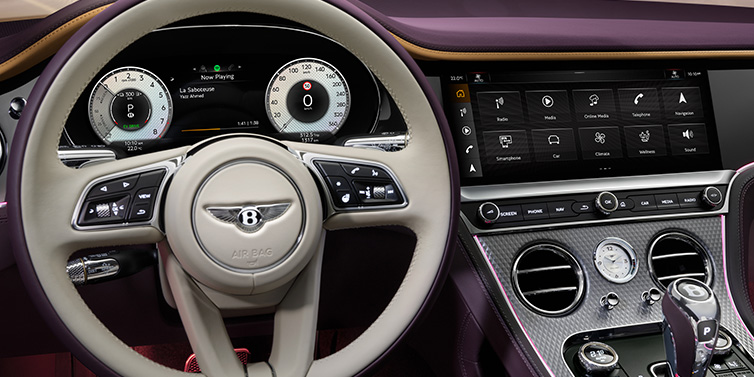 Bentley Zug Bentley Continental GTC Mulliner convertible steering wheel and drivers screens surrounded by Damson purple and Linen hides